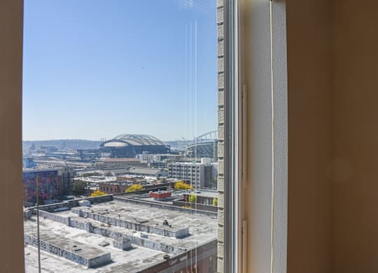 A view from a window looking out at a cityscape.