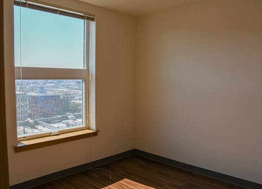 A room with a window overlooking a cityscape.