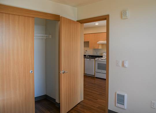 A kitchen is visible through a doorway.