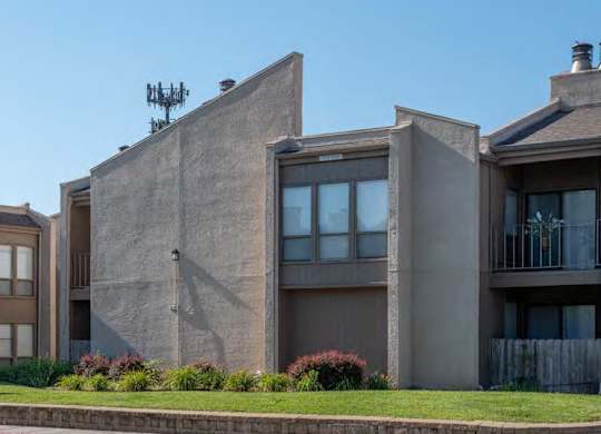 A modern building with a flat roof and a balcony.