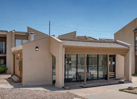 A modern house with a flat roof and a large glass door.
