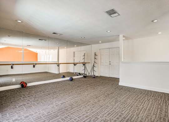A room with a grey carpet and a white ceiling.