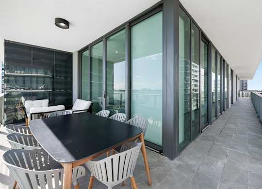 A modern dining area with a long table and chairs.