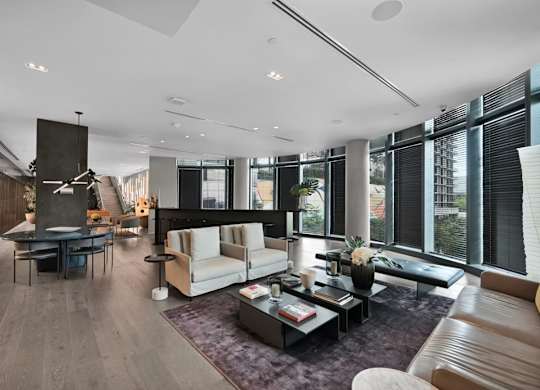 A modern living room with a fireplace and a large window.