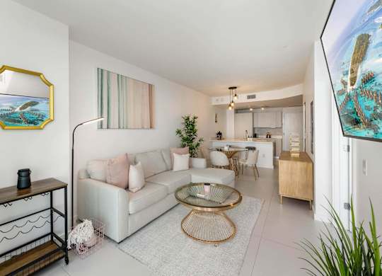 A living room with a white couch and a coffee table.