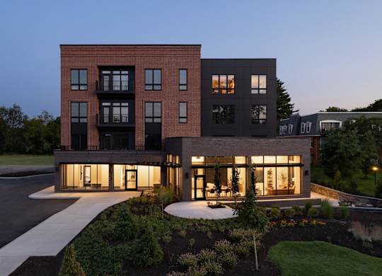 A modern two-story building with a mix of brick and glass facade.