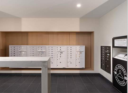 A modern kitchen with a white counter and wooden cabinets.