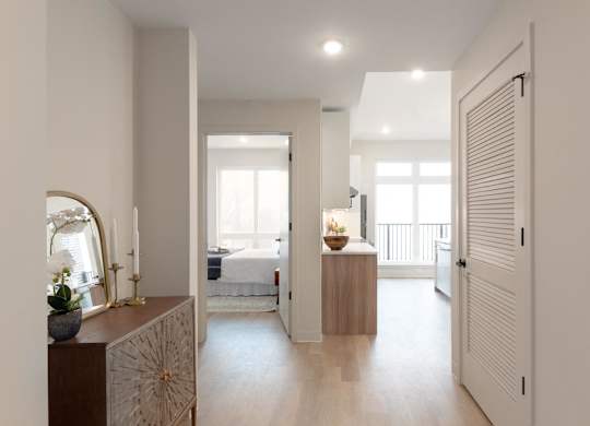 A bedroom with a bed, a dresser, and a mirror.