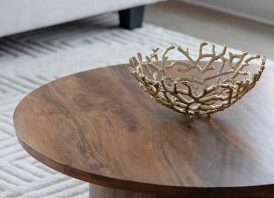 A wooden table with a crown shaped object on it.