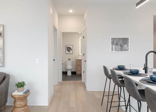 A modern dining room with a table set for two.