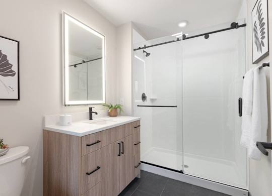 A modern bathroom with a white sink and a large mirror.