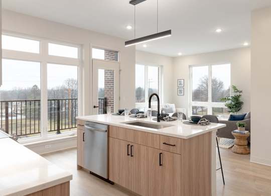 A modern kitchen with wooden cabinets and a large window.