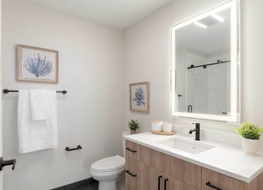 A white towel hangs on a towel rack in a bathroom.