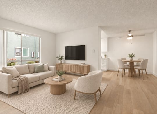 A living room with a couch, chairs, and a television.