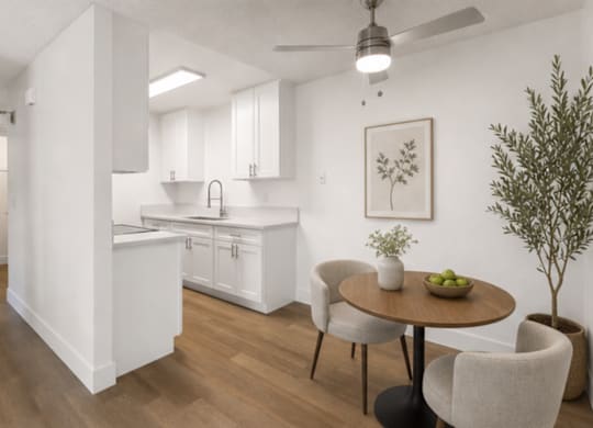 A modern kitchen with a dining table and chairs.