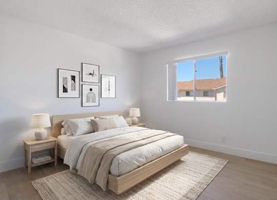 A bedroom with a large bed and a window overlooking a building.