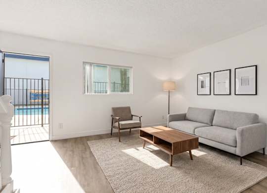 A living room with a grey couch, a chair, and a coffee table.