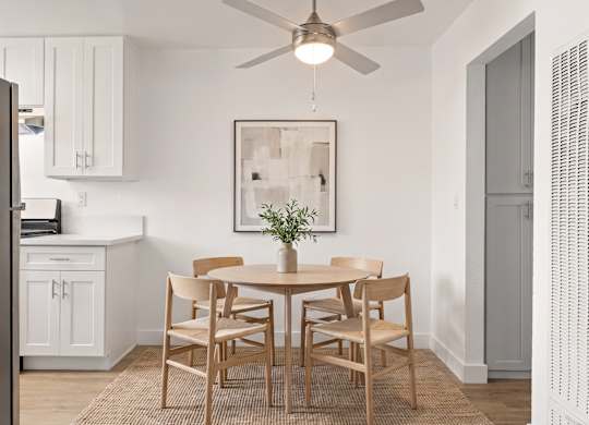 A dining room with a table set for six.