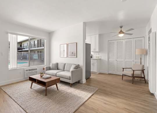 A living room with a couch, a coffee table, and a chair.