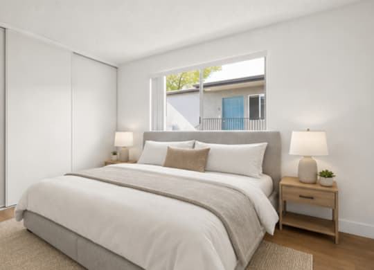 A bedroom with a large bed and a window.