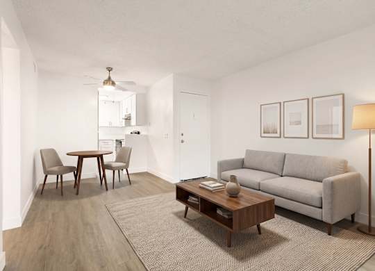 A living room with a grey couch, a coffee table, and a dining table with chairs.