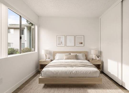 A bedroom with a bed, nightstands, and pictures on the wall.