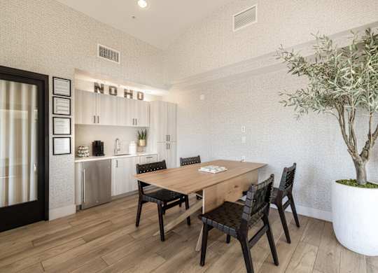 A dining room with a wooden table and chairs.