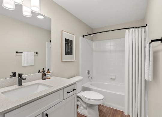 A bathroom with a white toilet and a white shower curtain.