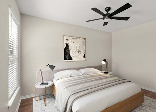 A bedroom with a bed, two lamps, and a painting on the wall.