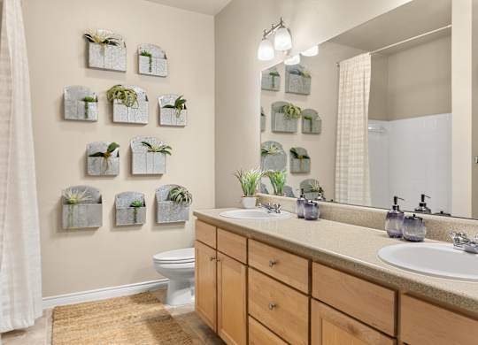 A bathroom with a white toilet, a sink, and a mirror.