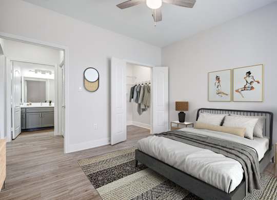 A bedroom with a large bed and a ceiling fan.
