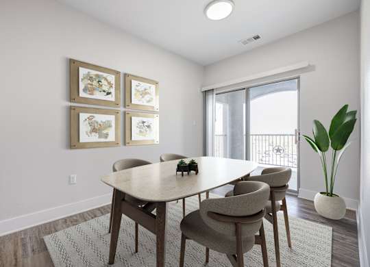 A dining room with a table and chairs.