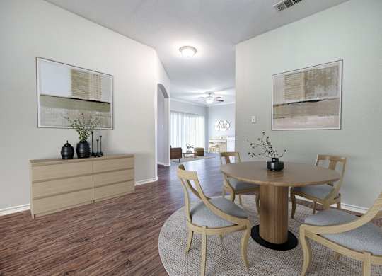 A dining room with a round table and chairs.