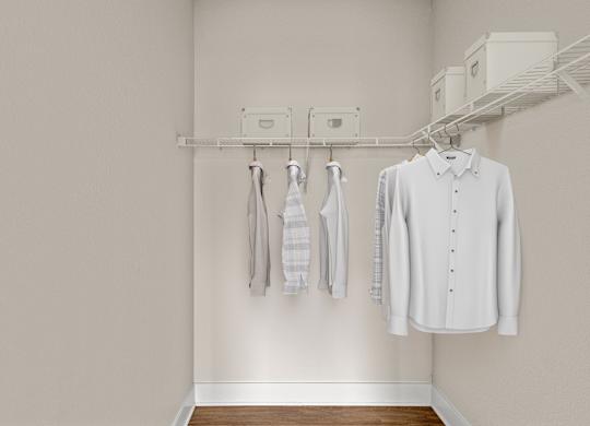 A white shirt hanging on a rack in a room.