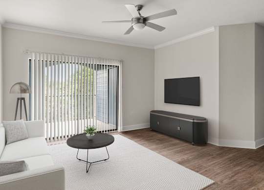 A living room with a white couch, a black coffee table, and a flat screen TV mounted on the wall.