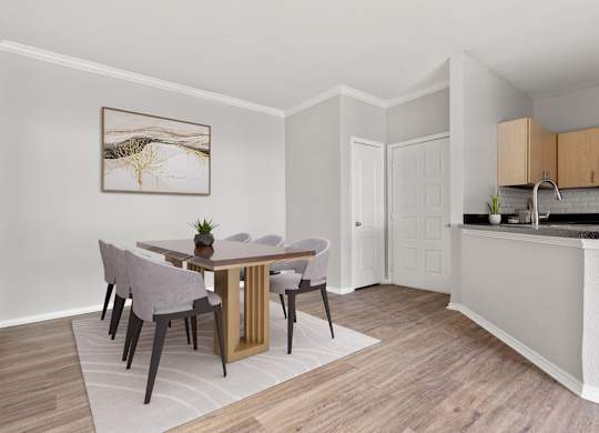 A dining room with a table and chairs.