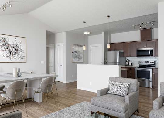 A modern dining room with a white table and grey chairs.