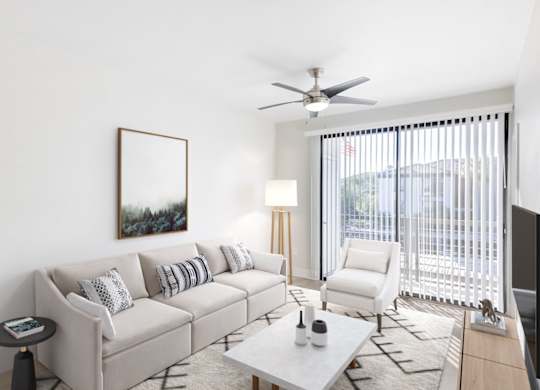 A living room with a white couch, a coffee table, and a painting on the wall.