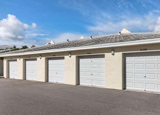A row of white garage doors are closed.