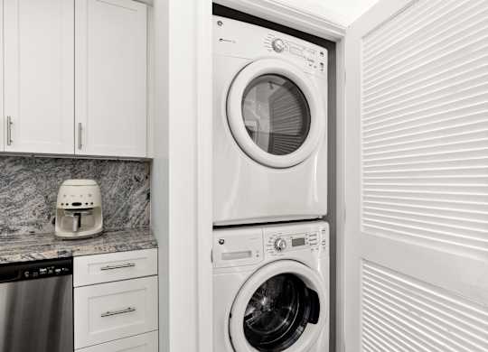 A white washing machine is in a laundry room.