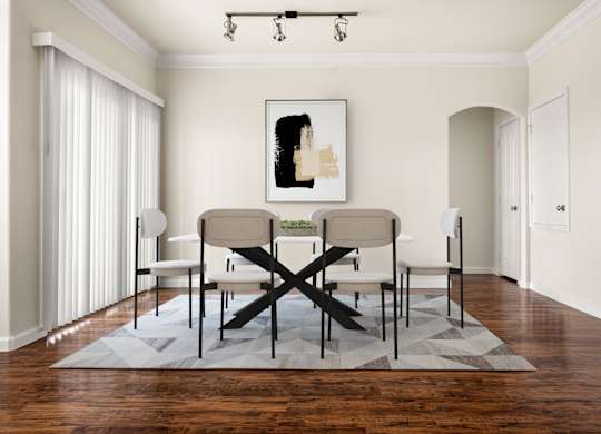 A dining room with a table and chairs.