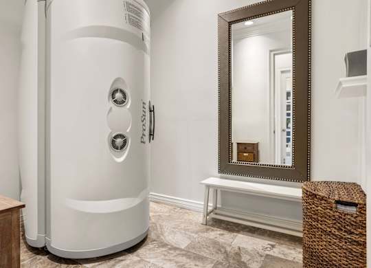 A white tankless water heater in a bathroom.