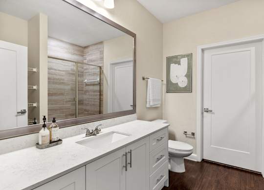 A bathroom with a white toilet and a white sink.