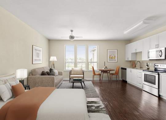 A well-lit, modern kitchen and living room with a large bed in the foreground.