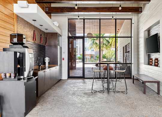A modern kitchen with a dining table and chairs.