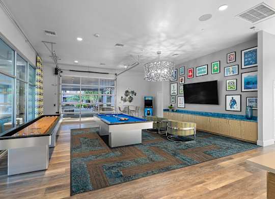 A room with a pool table and a bar.