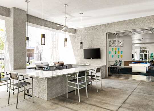 A modern kitchen with a large island and chairs.