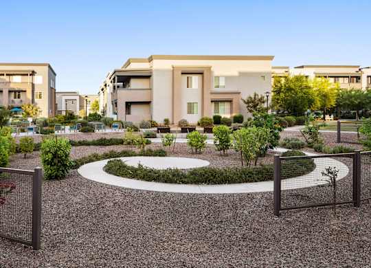 A modern building with a circular garden in front.