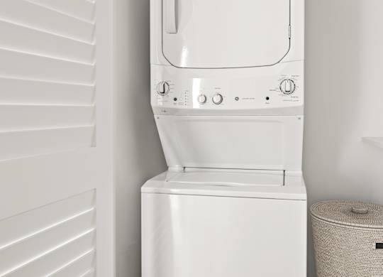 A white washing machine in a small room.
