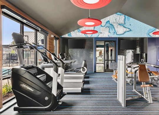 A gym with treadmills and exercise equipment.
